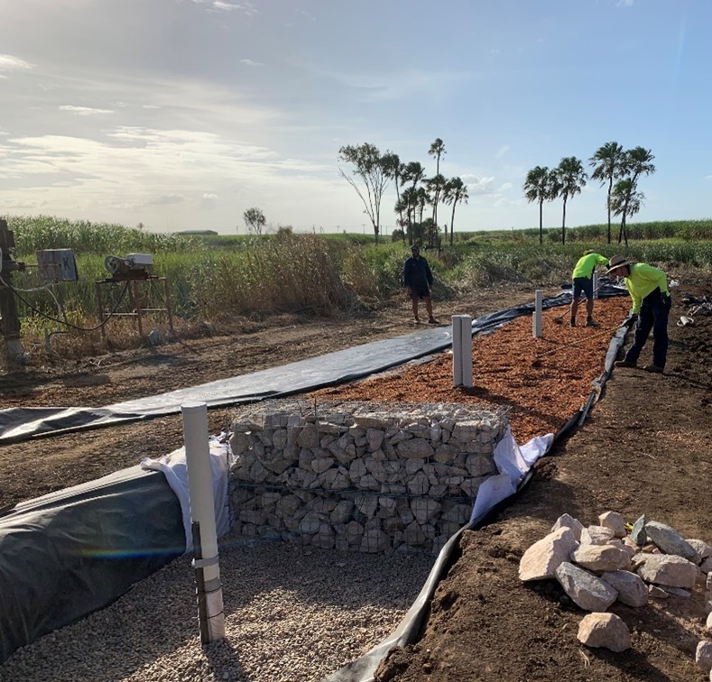 Figure 2 Construction of a bioreactor bed showing the inlet (foreground) and woodchip being levelled. Photo by Queensland Government