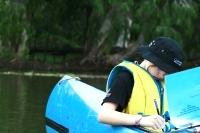 Child doing written work in canoe